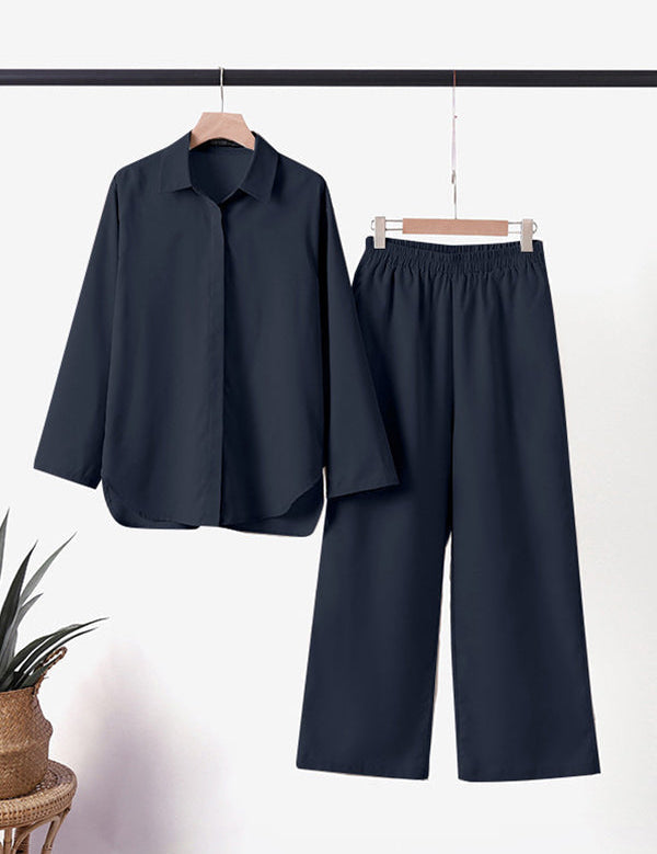 Completo pigiama donna nero, camicia maniche lunghe e pantaloni larghi, tessuto morbido, elegante e confortevole, ideale per la notte.