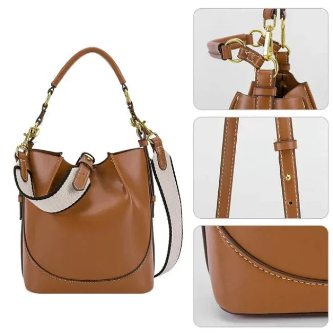 Borsa a secchiello in pelle marrone con dettagli in metallo dorato, tracolla regolabile e cuciture a contrasto. Design elegante e moderno.
