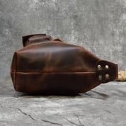 Borsa a tracolla in pelle marrone vintage, design robusto, cuciture a vista, ideale per uomo, moda casual, accessorio elegante e resistente.