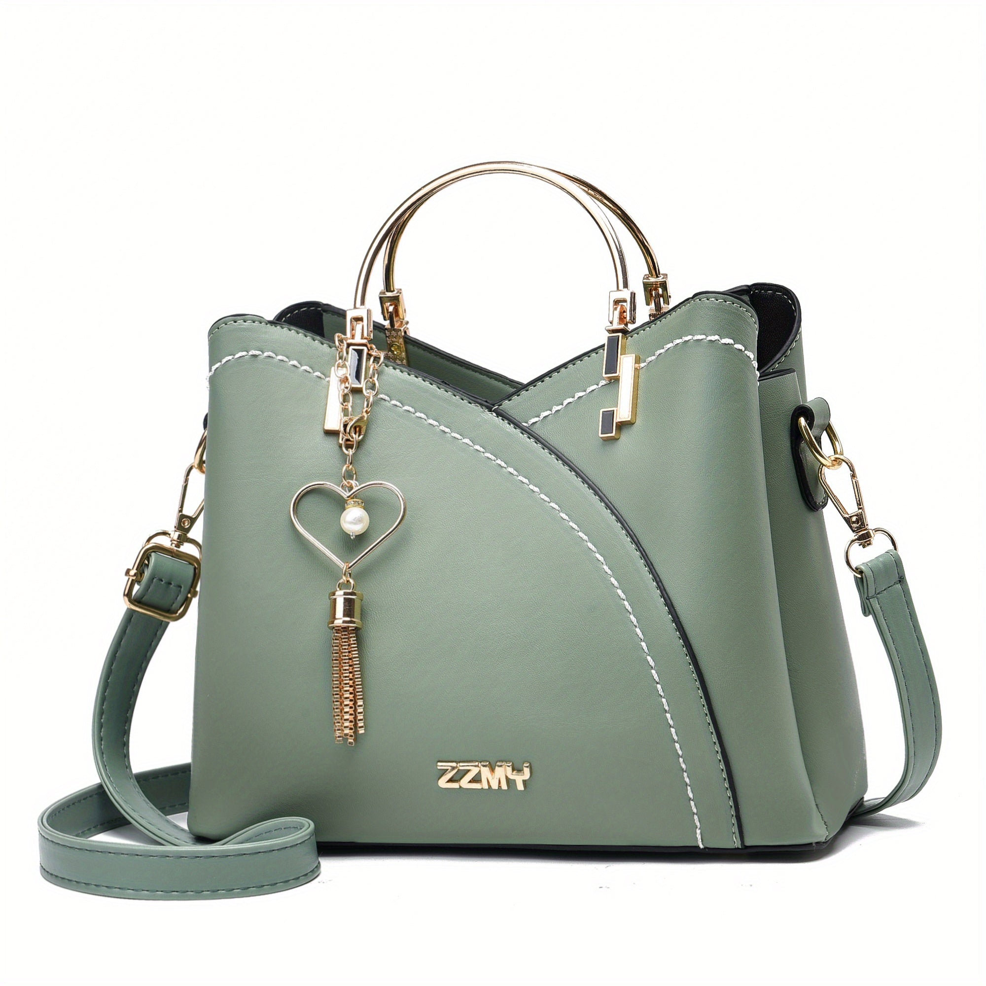Borsa a mano verde in pelle con manici dorati, tracolla regolabile e ciondolo decorativo. Elegante accessorio moda donna.