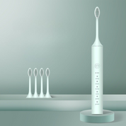Spazzolino elettrico bianco con base di ricarica e quattro testine di ricambio, design moderno, ideale per igiene orale avanzata e pulizia dentale.
