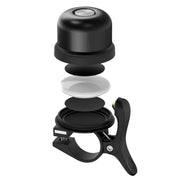 Campanello bici nero smontato, design moderno, componenti visibili: campana, meccanismo interno, supporto. Accessorio ciclismo essenziale.