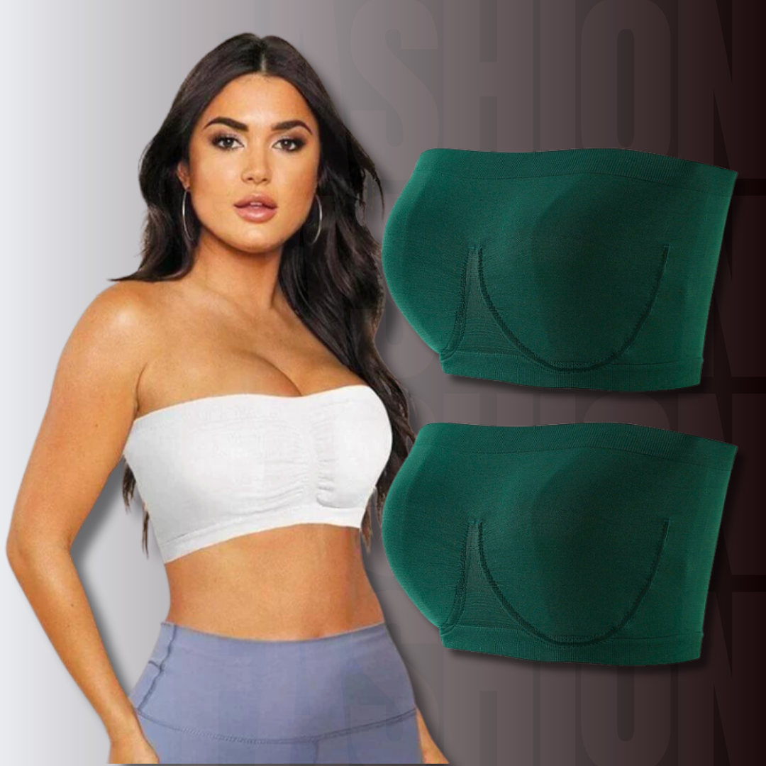 Donna con top bianco senza spalline, accanto a due reggiseni verde scuro senza spalline. Moda intima femminile, comfort, stile elegante.