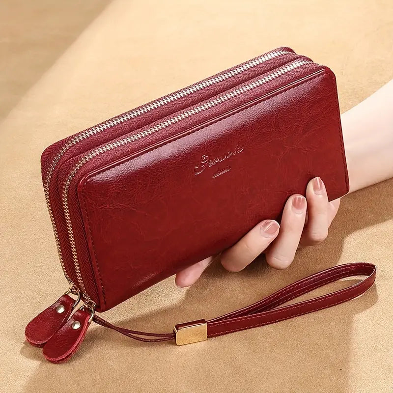 Portafoglio donna in pelle rossa con doppia cerniera, cinturino da polso, design elegante, ideale per moda e accessori femminili.