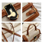 Borsa a tracolla in pelle marrone e tessuto beige, dettagli in metallo dorato, chiusura a girello, manico superiore, design elegante e moderno.