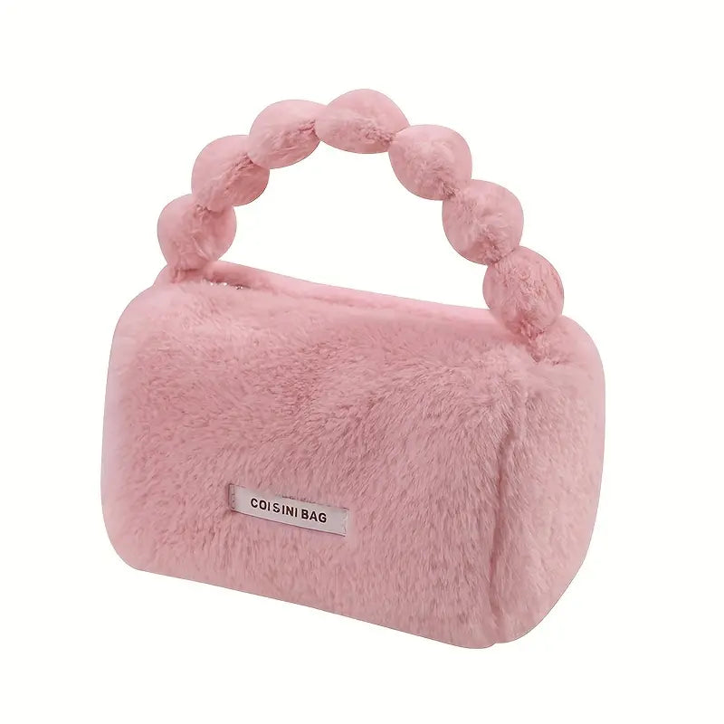 Borsa a mano rosa in pelliccia sintetica con manico a perle, design elegante e moderno, ideale per moda femminile e accessori autunno inverno.