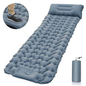Materassino gonfiabile grigio per campeggio con cuscino integrato, design a celle d'aria. Include pompa a pedale e custodia per trasporto.