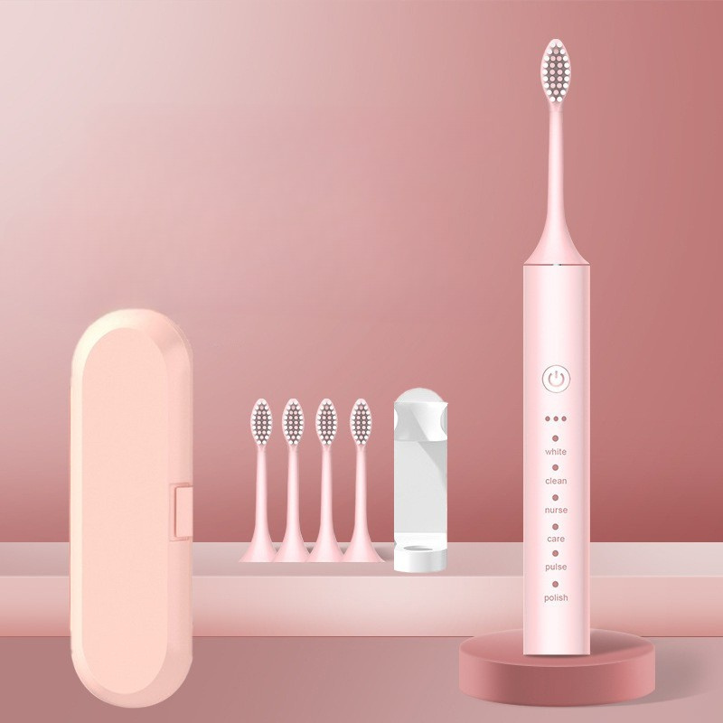 Spazzolino elettrico rosa con testine di ricambio, custodia da viaggio e base di ricarica. Design moderno, ideale per igiene orale quotidiana.