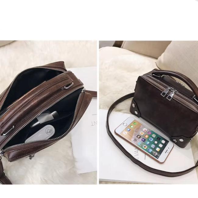 Borsa a tracolla in pelle marrone con zip, design compatto, ideale per smartphone e accessori. Elegante e pratica per l'uso quotidiano.