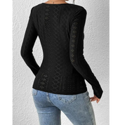 Maglia nera a maniche lunghe in pizzo traforato, indossata con jeans blu. Design elegante e moderno, ideale per moda casual e serate.
