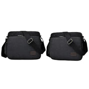 Due borse a tracolla nere in tessuto resistente, con cerniera e tasche multiple, ideali per laptop e accessori. Design moderno e funzionale.