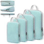 Set di organizer da viaggio in tessuto azzurro, con cerniere e manici, in quattro diverse dimensioni. Ideale per valigie e bagagli.