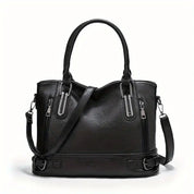 Borsa a mano in pelle nera con doppio manico e tracolla regolabile, design elegante con cerniere decorative, ideale per moda donna.