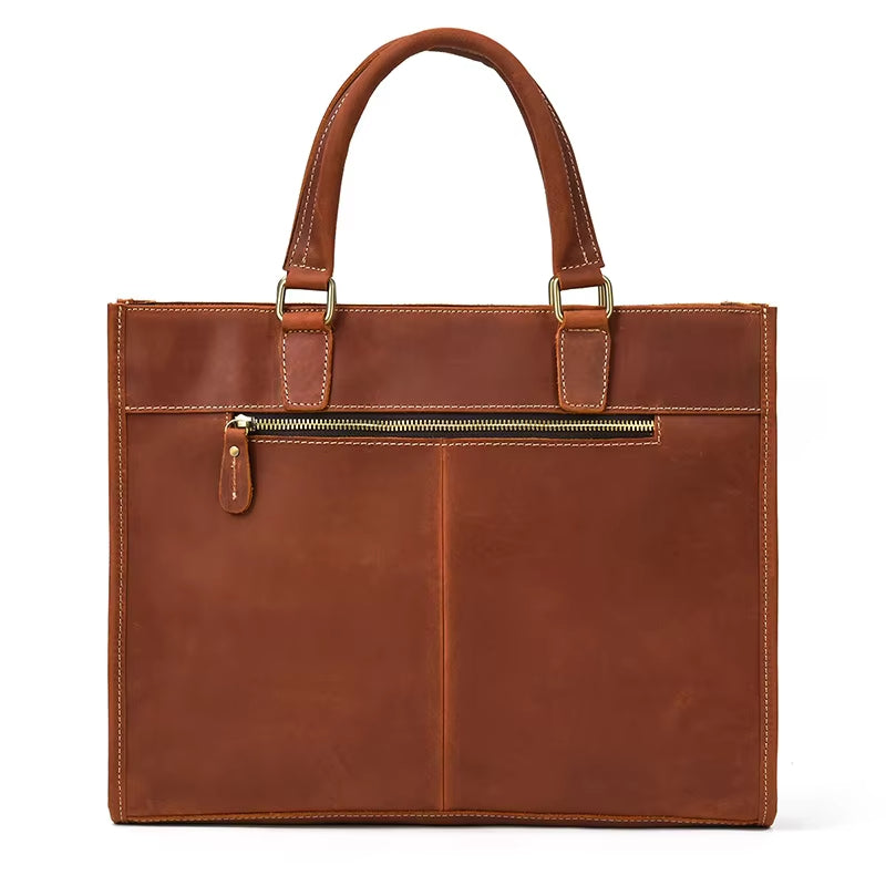 Borsa tote in pelle marrone con manici robusti e tasca frontale con cerniera. Elegante e spaziosa, ideale per lavoro e uso quotidiano.