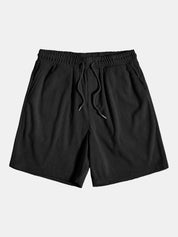 Pantaloncini neri a righe verticali, elastico in vita con laccio, tasche laterali. Ideali per moda casual estiva, uomo.