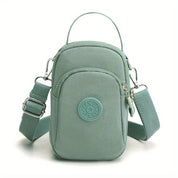Borsa a tracolla verde menta in nylon, compatta e resistente, con cerniera e tasche multiple. Ideale per viaggi e uso quotidiano.