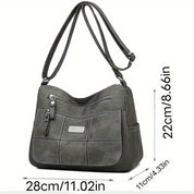 Borsa a tracolla in pelle grigia, dimensioni 28x22x11 cm, con tasche multiple e cerniere, design elegante e pratico per uso quotidiano.