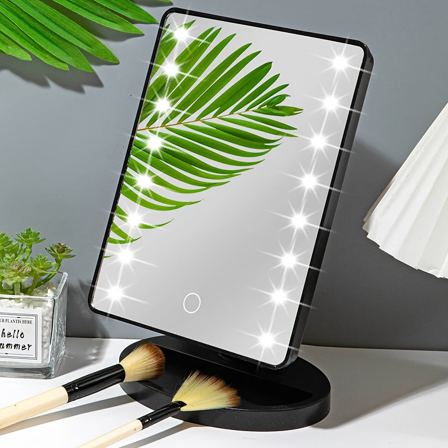 Specchio cosmetico LED rettangolare con foglia verde riflessa, base nera, pennelli trucco, decorazione moderna, illuminazione regolabile.