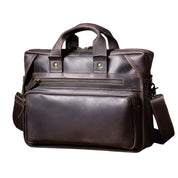 Borsa ventiquattrore in pelle marrone scuro con manici e tracolla regolabile, tasche multiple con cerniera, design elegante e professionale.