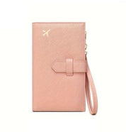 Portafoglio da viaggio rosa con cinturino, decorato con icona dorata di aereo. Accessorio elegante per organizzare documenti e carte.