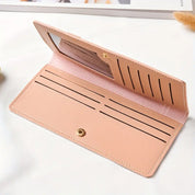 Portafoglio donna in pelle rosa chiaro con chiusura a bottone, scomparti per carte di credito e finestra trasparente, elegante e funzionale.
