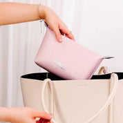 Borsa a mano beige con pochette rosa, elegante e moderna, perfetta per moda femminile. Accessorio di tendenza per ogni occasione.