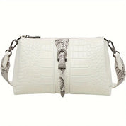 Borsa a tracolla bianca in pelle effetto coccodrillo, dettagli fibbia e cinturino regolabile. Elegante accessorio moda donna.