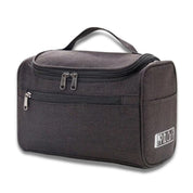 Borsa da toilette nera con manico, doppia cerniera, tasca frontale, ideale per viaggio, organizzazione accessori bagno, resistente e compatta.
