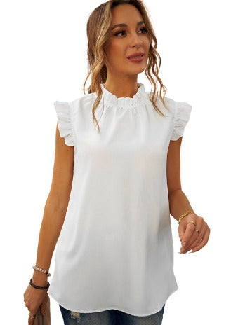 Blusa bianca senza maniche con volant, scollo arricciato, indossata da donna. Moda estiva elegante, perfetta per look casual e raffinati.