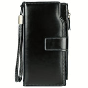 Portafoglio donna in pelle nera con chiusura a scatto, cuciture bianche e cinturino da polso. Elegante accessorio moda, ideale per ogni occasione.