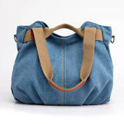 Borsa a mano in denim blu con manici beige, design casual e spazioso, ideale per uso quotidiano. Accessorio moda donna, stile versatile e pratico.