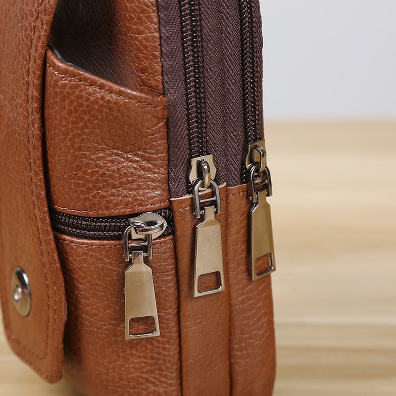 Borsa a tracolla in pelle marrone con doppie cerniere metalliche, design elegante e pratico, ideale per uomo e donna. Accessorio moda versatile.