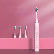 Spazzolino elettrico rosa con tre testine di ricambio su sfondo rosa. Design elegante, tecnologia avanzata, cura dentale efficace.
