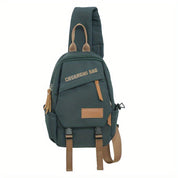 Zaino monospalla verde scuro con dettagli in pelle marrone, tasche multiple e cerniere, ideale per viaggi e uso quotidiano.
