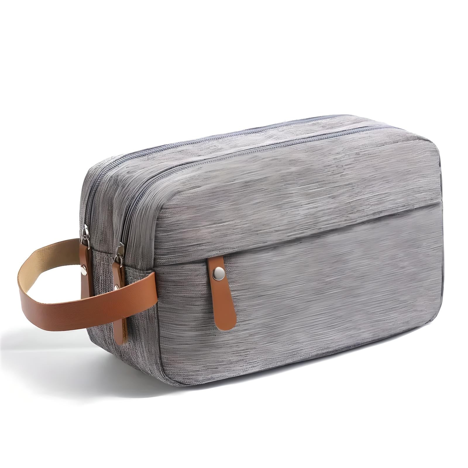 Borsa da toilette grigia con manico in pelle marrone, design moderno, ideale per viaggi, organizer da bagno, resistente e spaziosa.
