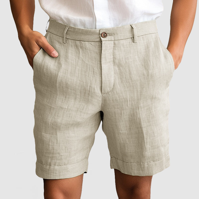 Pantaloncini uomo in lino beige, eleganti e casual, con tasche laterali. Ideali per l'estate, abbinati a camicia bianca. Moda maschile estiva.