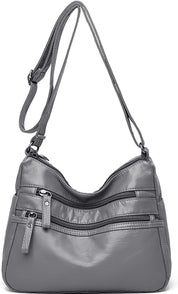 Borsa a tracolla in pelle grigia con cerniere multiple, design elegante e pratico, ideale per donna. Accessorio moda versatile e spazioso.
