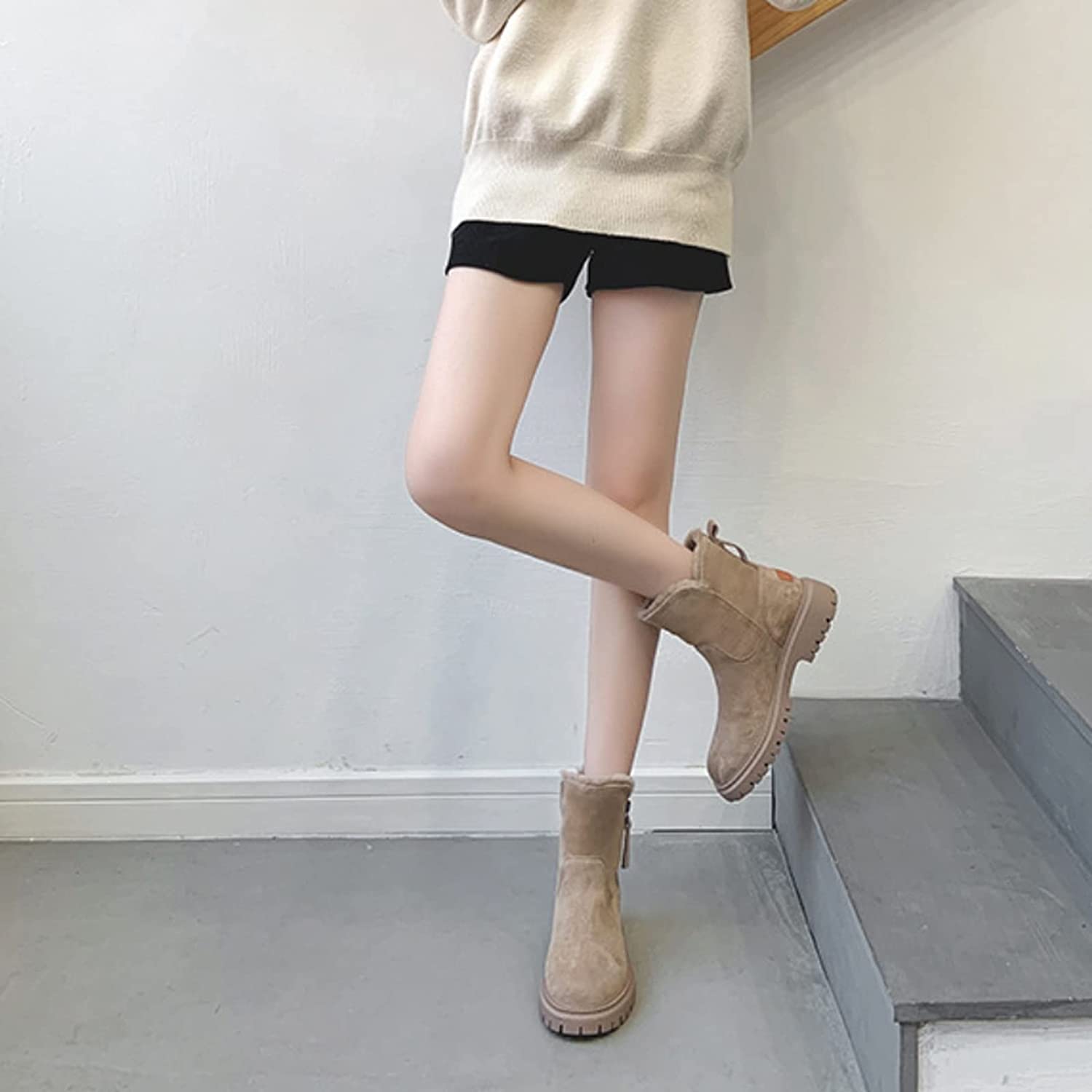 Stivali invernali beige da donna, suola antiscivolo, indossati con pantaloncini neri e maglione chiaro, moda casual autunnale.