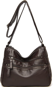 Borsa a tracolla in pelle marrone scuro con cerniere multiple, design elegante e pratico, ideale per donna. Accessorio moda versatile e di tendenza.