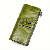 Portafoglio donna in pelle verde, design elegante con chiusura a bottone e zip laterale. Accessorio moda, alta qualità, stile contemporaneo.