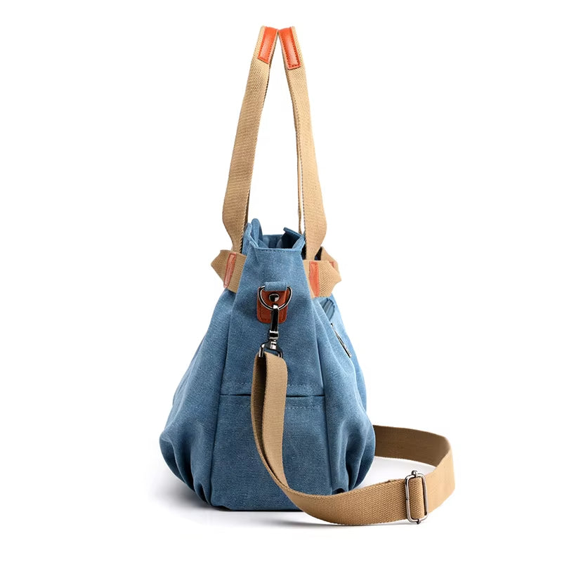 Borsa a tracolla in tela blu, design casual, con manici beige e dettagli in pelle marrone. Ideale per moda donna, accessori versatili.