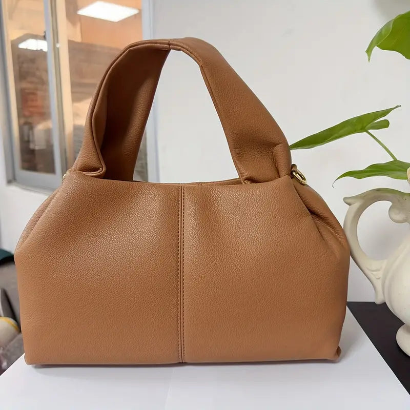 Borsa a mano in pelle marrone chiaro, design elegante e moderno, perfetta per moda donna. Accessorio versatile per ogni occasione.