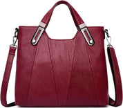 Borsa a mano in pelle rossa con tracolla regolabile, design elegante e moderno, accessori metallici, ideale per moda donna e shopping.