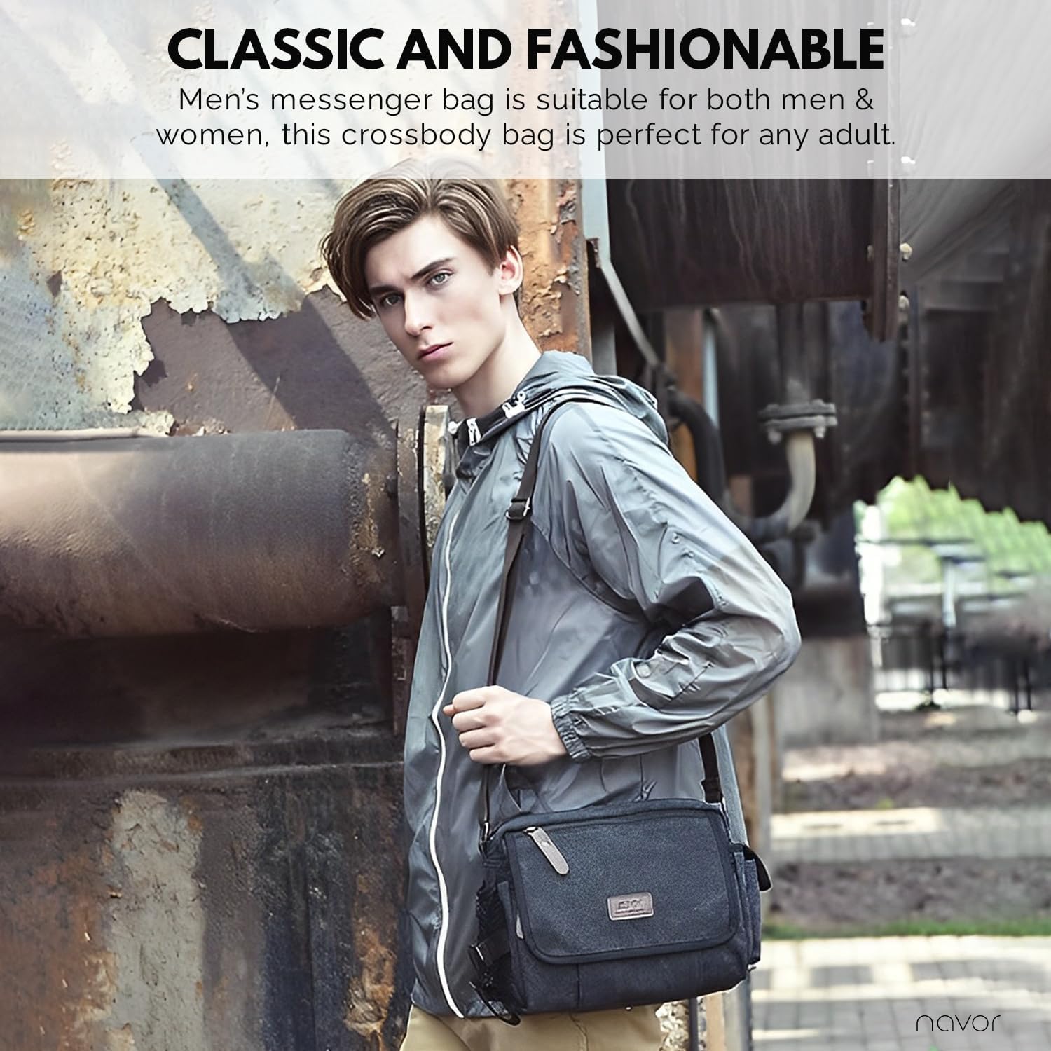 Giovane con borsa a tracolla nera in tessuto, giacca grigia, sfondo industriale. Borsa messenger unisex, moda urbana, accessorio versatile.