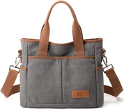Borsa a tracolla in tela grigia con manici marroni, tasche esterne e tracolla regolabile. Design casual, ideale per uso quotidiano e shopping.