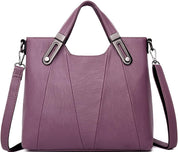 Borsa a tracolla in pelle viola da donna con manici rinforzati e tracolla regolabile. Design elegante, ideale per moda e shopping.