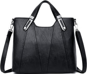 Borsa a mano in pelle nera elegante con tracolla regolabile, design moderno, dettagli metallici, perfetta per moda donna e uso quotidiano.