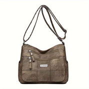 Borsa a tracolla in pelle marrone con tasche multiple e cerniere, design elegante e pratico, ideale per donna, moda accessori, shopping.