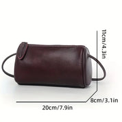 Borsetta cilindrica in pelle marrone scuro con cerniera, dimensioni 20x8x11 cm, elegante e compatta, ideale per accessori moda e uso quotidiano.