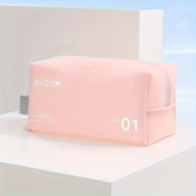 Astuccio da viaggio rosa chiaro con cerniera, design minimalista, ideale per cosmetici e accessori. Perfetto per organizzare in viaggio.